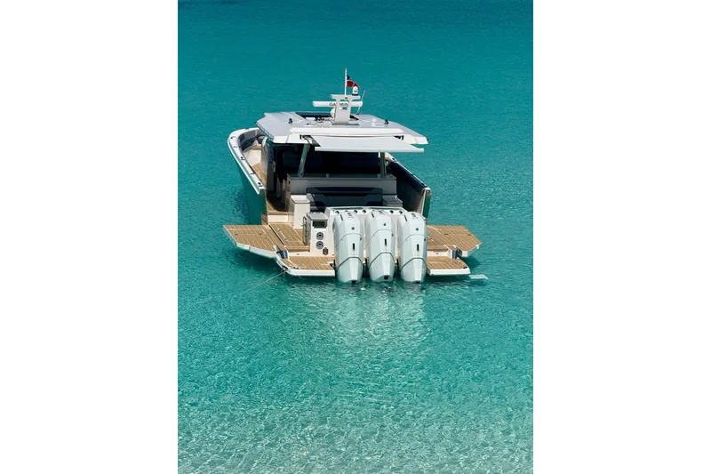 Slide: The Image of 2026 Regal 50 SAV yacht with triple engines on turquoise water. - 34