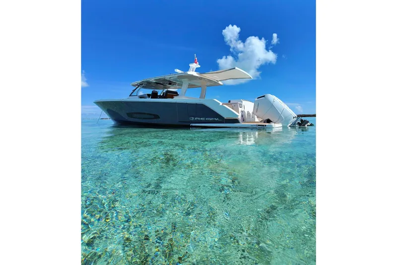 Slide: The Image of 2026 Regal 50 SAV boat on clear turquoise water under a bright blue sky. - 36