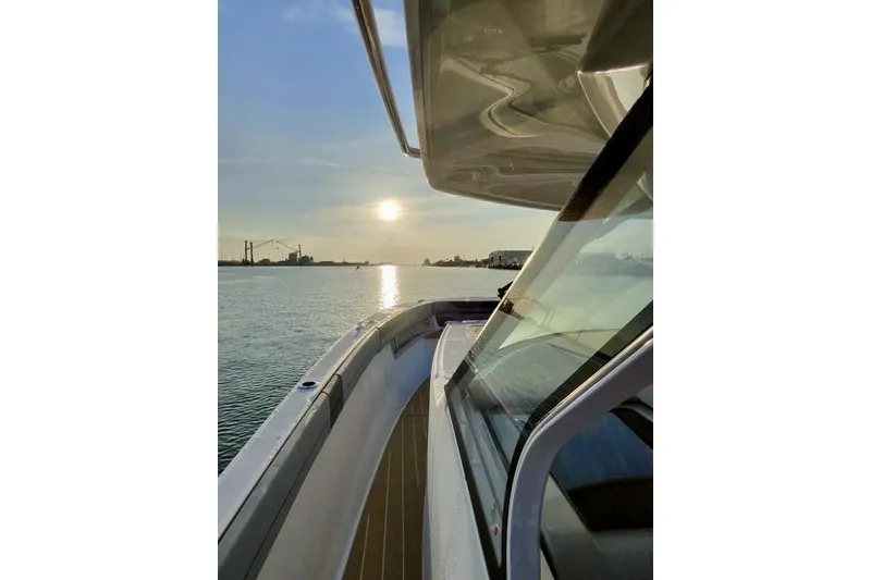 Slide: The Image of 2026 Regal 50 SAV yacht cruising at sunset on calm waters. - 38