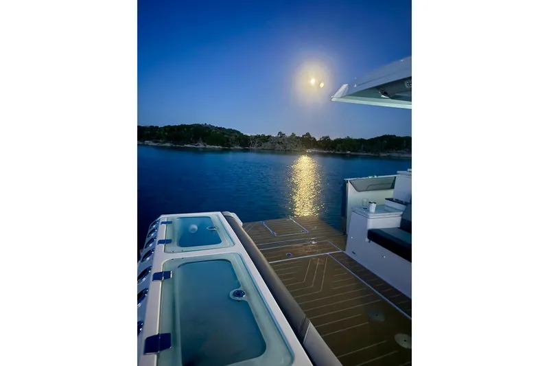 Slide: The Image of 2026 Regal 50 SAV yacht at night, moonlit water view from deck. - 40