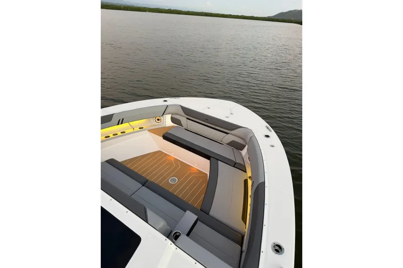 Slide: The Image of Luxurious 2026 Regal 50 SAV boat interior with elegant seating and ambient lighting on calm water. - 8