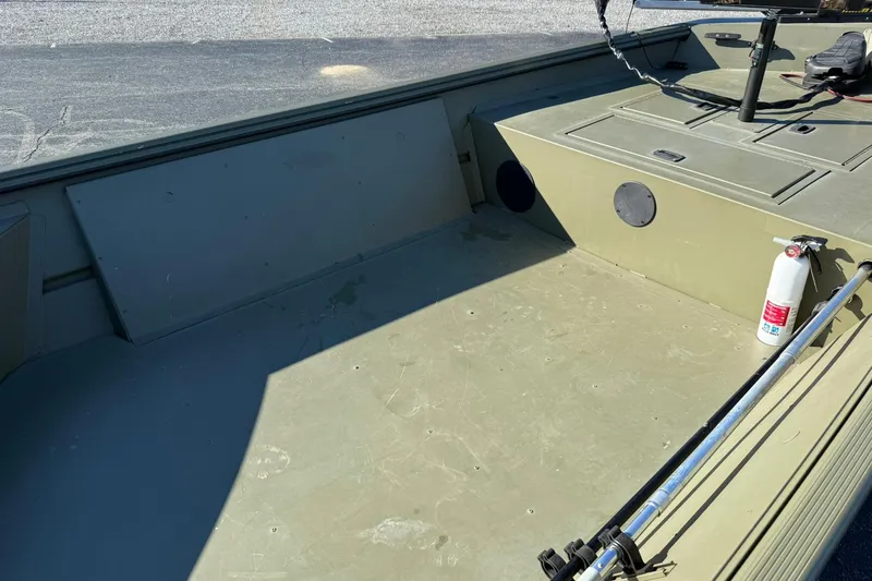 Slide: The Image of 2014 Lowe Roughneck 1650 DLX boat interior with fire extinguisher and storage compartments. - 14