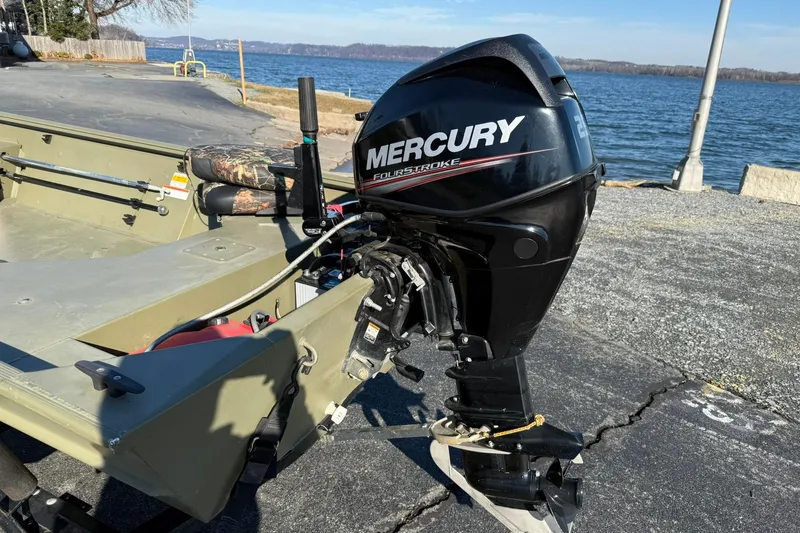 Slide: The Image of 2014 Lowe Roughneck 1650 DLX boat with Mercury FourStroke engine by a lake. - 4