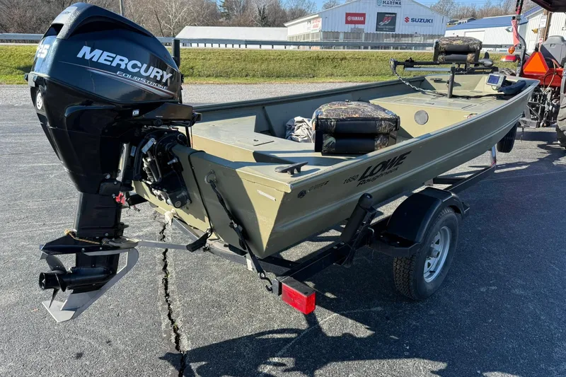 Slide: The Image of 2014 Lowe Roughneck 1650 DLX boat with Mercury outboard motor on trailer. - 6