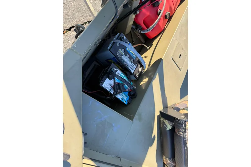 Slide: The Image of 2014 Lowe Roughneck 1650 DLX boat interior showing battery compartment and fuel tank. - 7