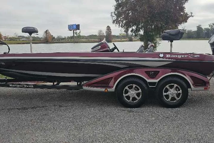 The Image of 2015 Ranger Z521 Comanche boat on trailer by a lake. - 0