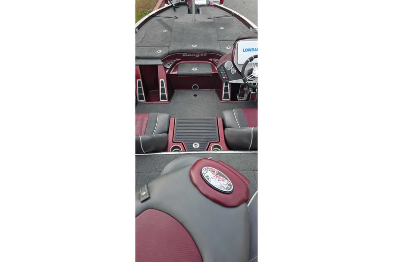 Slide: The Image of 2015 Ranger Z521 Comanche boat interior with maroon and black seating, steering console, and storage compartments. - 3