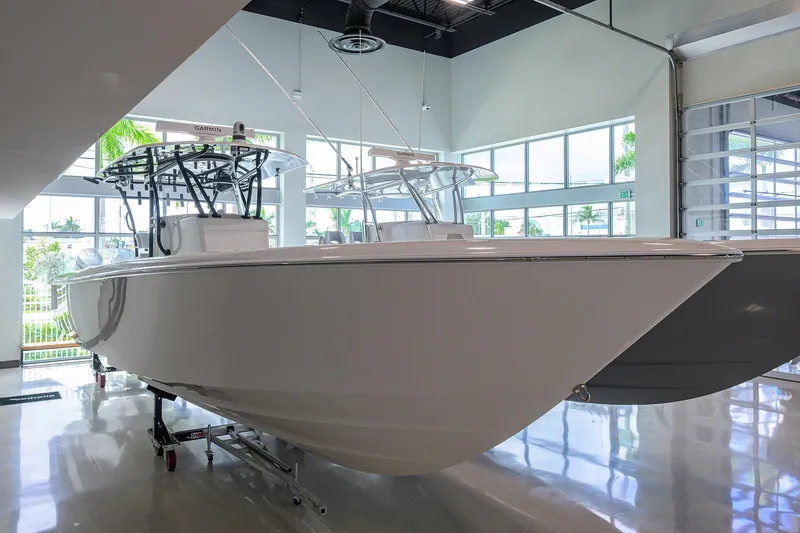 The Image of 2026 Contender 39 ST boat displayed in a modern showroom with large windows. - 0