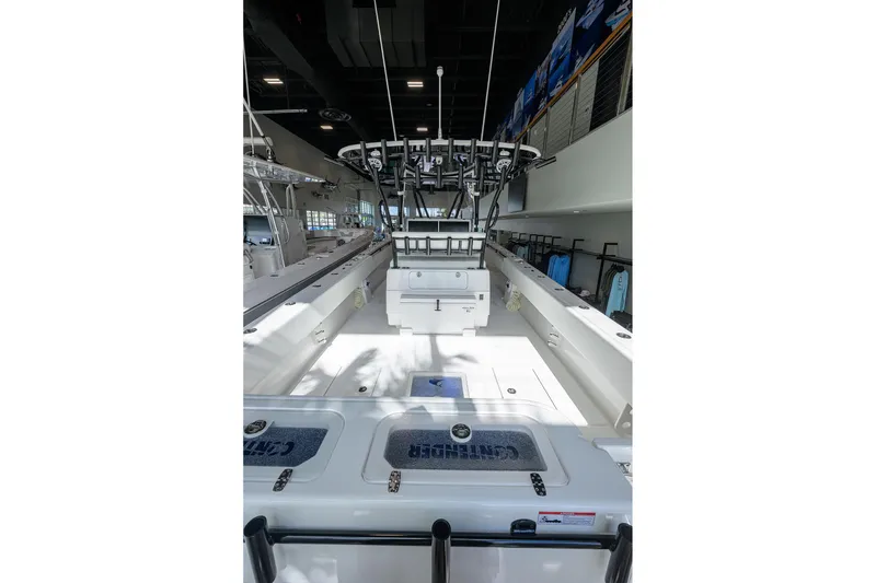 Slide: The Image of 2026 Contender 39 ST boat interior with fishing rod holders and storage compartments. - 16