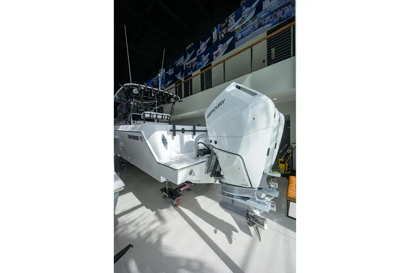 Slide: The Image of 2026 Contender 39 ST boat with powerful Mercury outboard engines in showroom. - 17