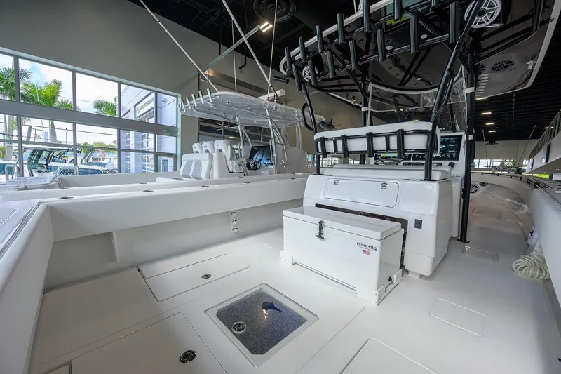 Slide: The Image of 2026 Contender 39 ST boat interior with seating and storage in showroom. - 20