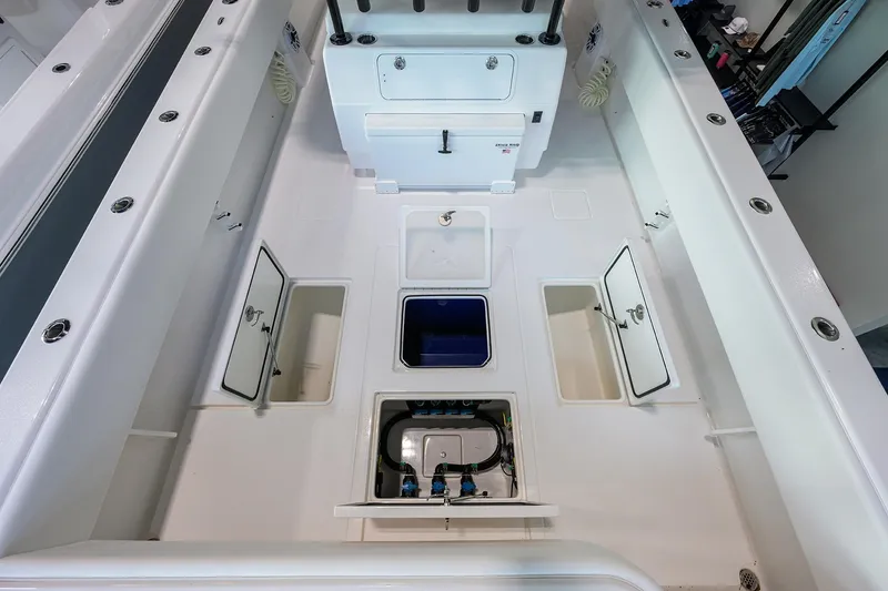 Slide: The Image of 2026 Contender 39 ST boat interior with storage compartments and clean white deck. - 21