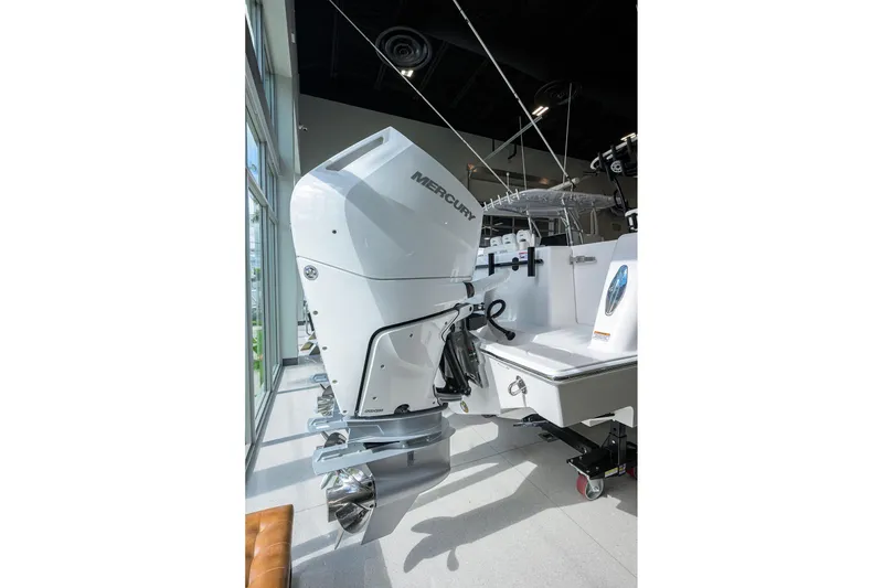 Slide: The Image of 2026 Contender 39 ST boat with Mercury outboard engine in showroom. - 25