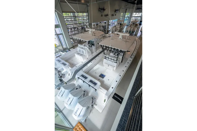 Slide: The Image of 2026 Contender 39 ST boat with multiple outboard engines in a showroom. - 26