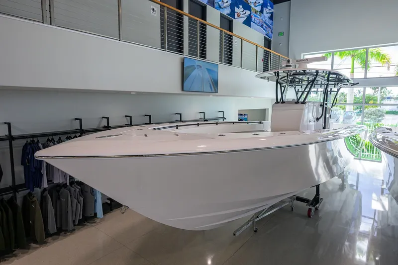 Slide: The Image of 2026 Contender 39 ST boat displayed indoors, sleek design, modern showroom setting. - 3