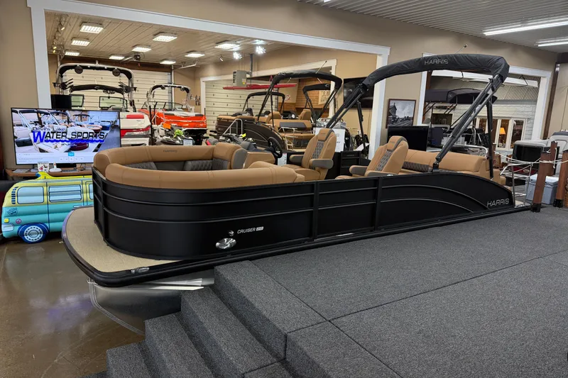 The Image of 2026 Harris Cruiser 210 pontoon boat displayed in a showroom with modern interior design. - 1
