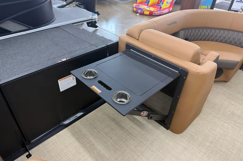 Slide: The Image of 2026 Harris Cruiser 210 boat interior with foldable table and cup holders. - 11