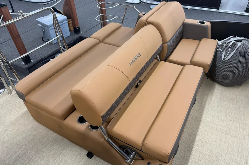 Slide: The Image of 2026 Harris Cruiser 210 boat seating with tan upholstery and cup holders. - 14