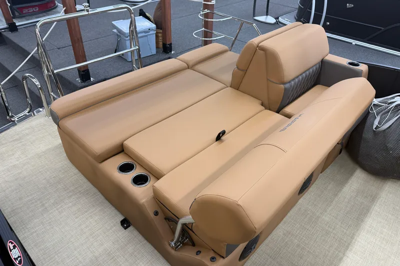 Slide: The Image of Luxurious seating on 2026 Harris Cruiser 210 boat with tan upholstery and cup holders. - 15