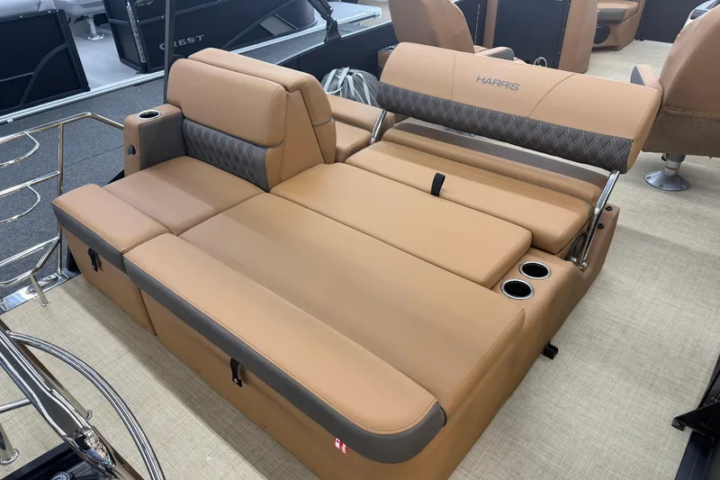 Slide: The Image of Luxurious seating on 2026 Harris Cruiser 210 boat with tan upholstery and cup holders. - 16
