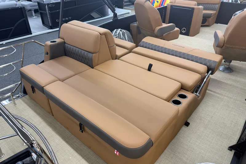 Slide: The Image of 2026 Harris Cruiser 210 boat interior with tan seating and cup holders. - 17