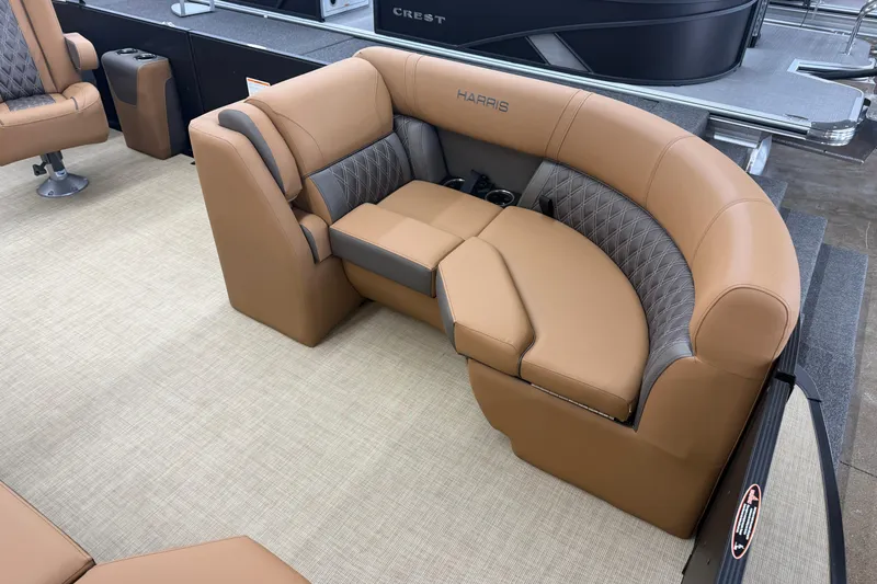 Slide: The Image of Luxurious seating on 2026 Harris Cruiser 210 pontoon boat, featuring tan and gray upholstery. - 3