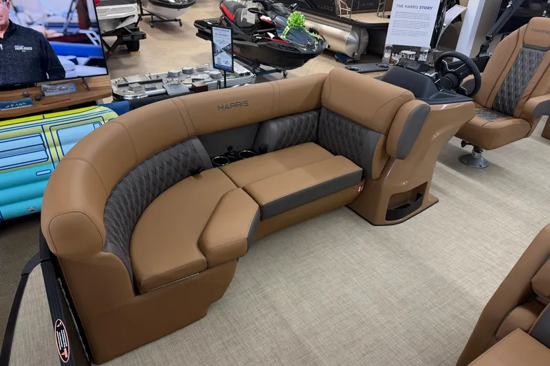 Slide: The Image of 2026 Harris Cruiser 210 boat interior with tan and gray seating in showroom. - 4