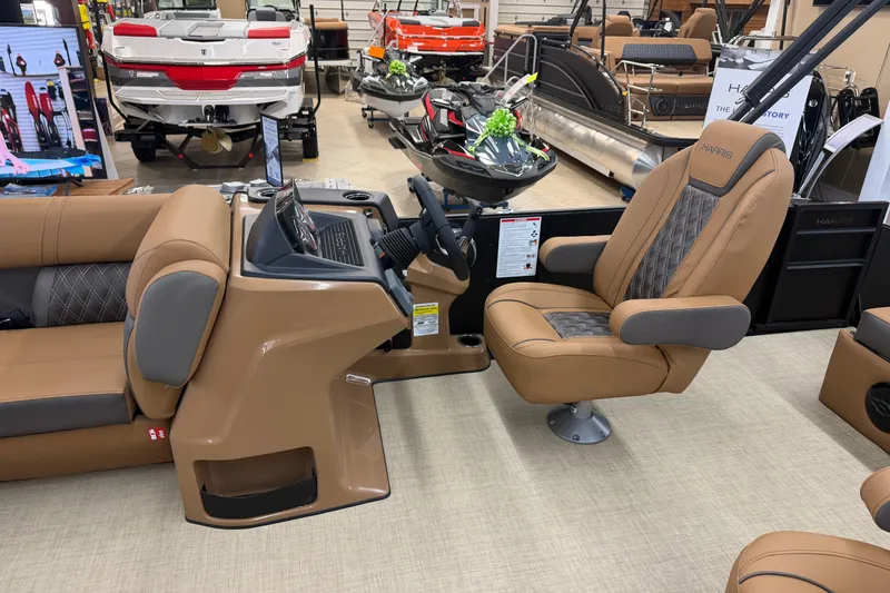 Slide: The Image of 2026 Harris Cruiser 210 boat interior with tan seating and modern dashboard. - 5