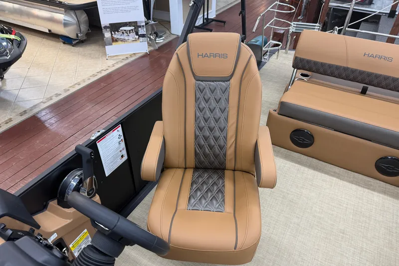 Slide: The Image of 2026 Harris Cruiser 210 boat interior with tan and gray seating. - 7