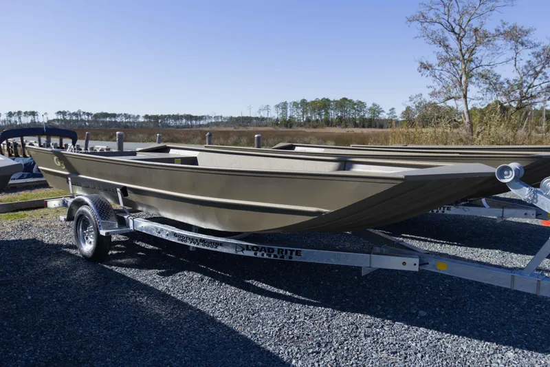 The Image of 2026 G3 Gator Tough 1860 VBW boat on trailer, outdoors, clear sky. - 1