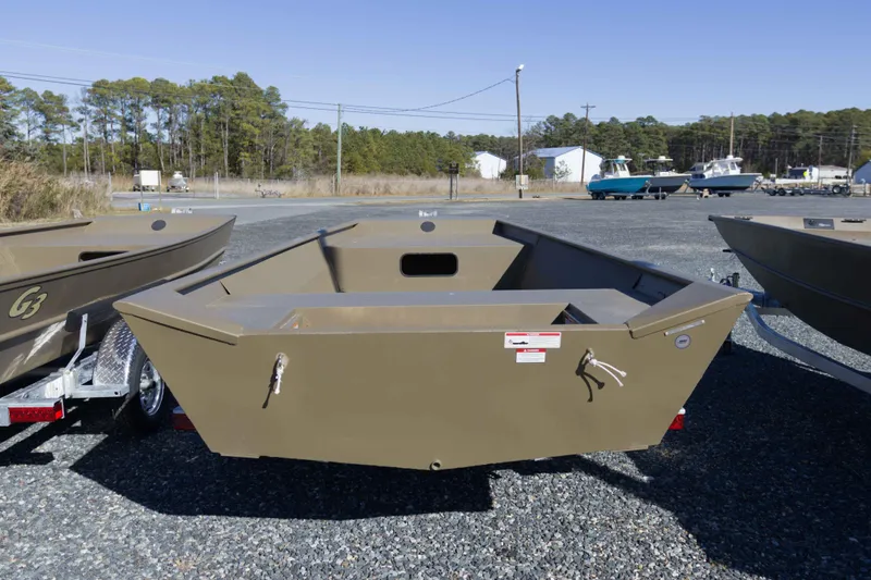 Slide: The Image of 2026 G3 Gator Tough 1860 VBW boat on trailer in outdoor lot. - 3
