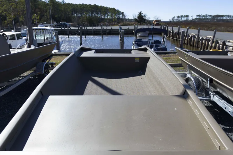 Slide: The Image of 2026 G3 Gator Tough 1860 VBW boat at marina, surrounded by other vessels. - 4