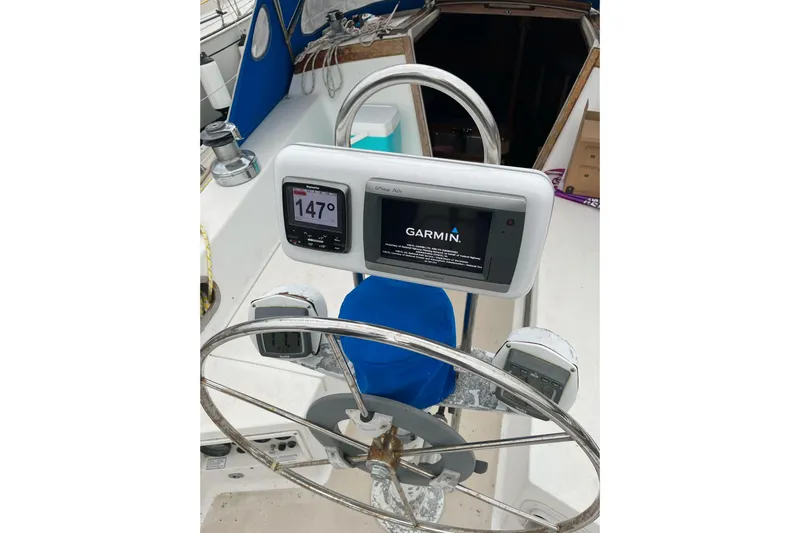Slide: The Image of Cockpit of 1985 Catalina 36 sailboat with Garmin navigation system and steering wheel. - 13