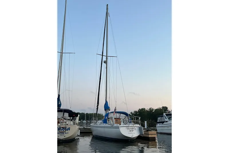 Slide: The Image of 1985 Catalina 36 sailboat docked at sunset, calm waters, clear sky. - 14