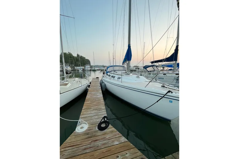 Slide: The Image of 1985 Catalina 36 sailboat docked at marina during sunset. - 16