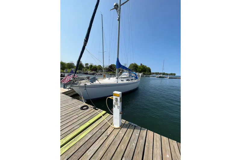 Slide: The Image of 1985 Catalina 36 sailboat docked at a marina on a sunny day. - 19