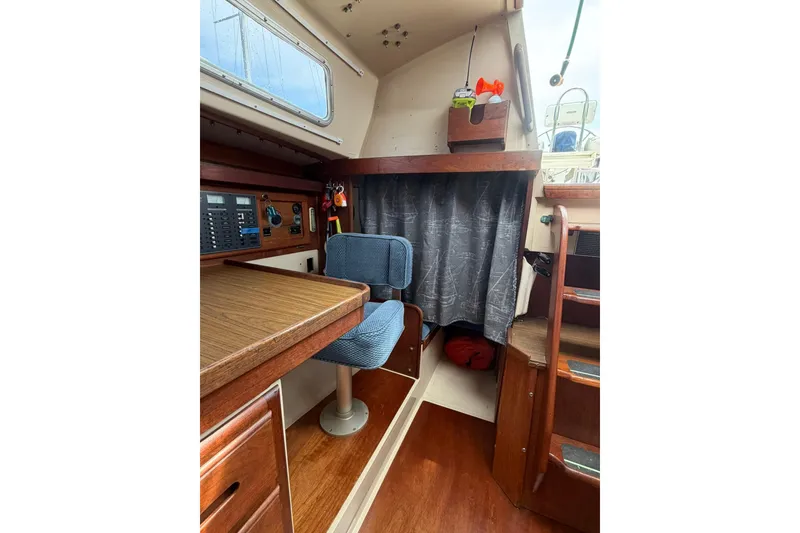 Slide: The Image of Interior of 1985 Catalina 36 sailboat with navigation station and seating area. - 26