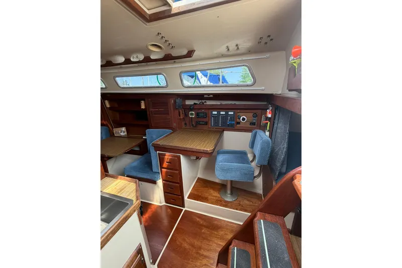 Slide: The Image of Interior of 1985 Catalina 36 sailboat with wood finish and blue seating. - 28