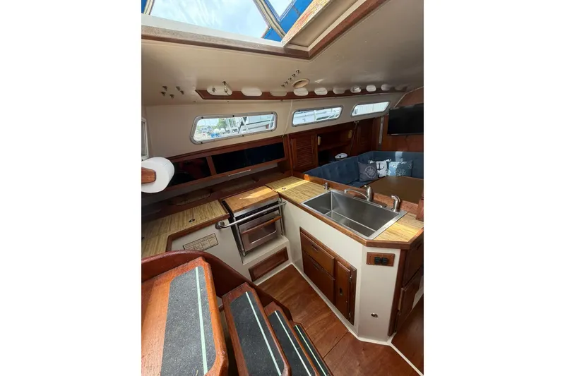 Slide: The Image of Interior of 1985 Catalina 36 sailboat with kitchen, sink, and seating area. - 30