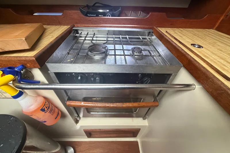 Slide: The Image of 1985 Catalina 36 yacht kitchen with stove and wooden countertops. - 31