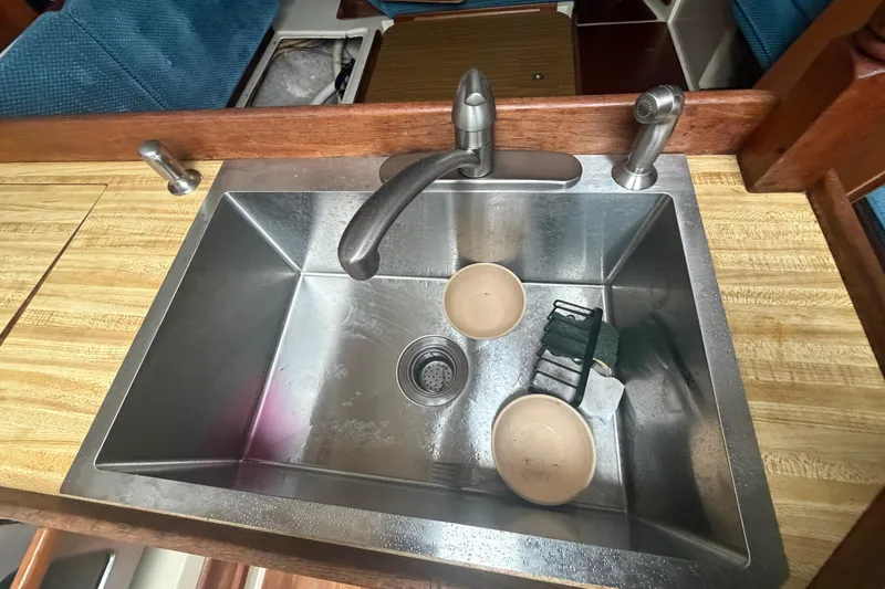 Slide: The Image of Stainless steel sink with dishes in a 1985 Catalina 36 yacht kitchen. - 34