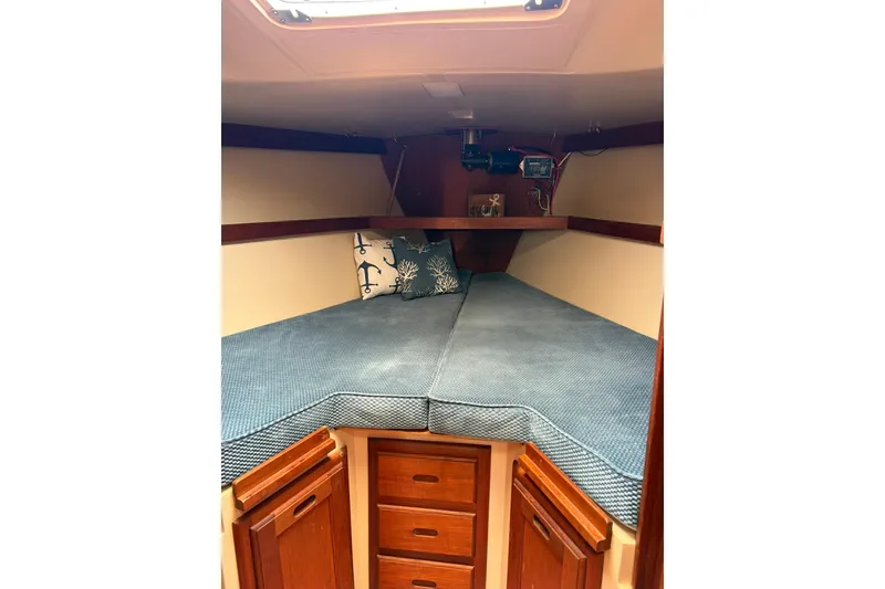 Slide: The Image of Cozy cabin interior of 1985 Catalina 36 sailboat with blue bedding and wooden storage. - 41