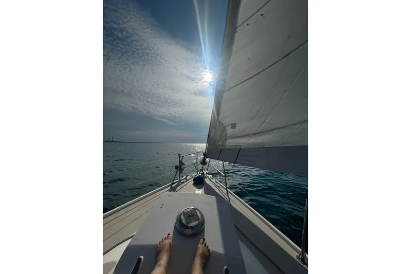 Slide: The Image of Sailing on a 1985 Catalina 36 yacht under a sunny sky, with visible sails. - 6