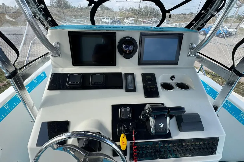 Slide: The Image of 1996 Pro-Line 3400 Cuddy boat dashboard with navigation screens and controls. - 12