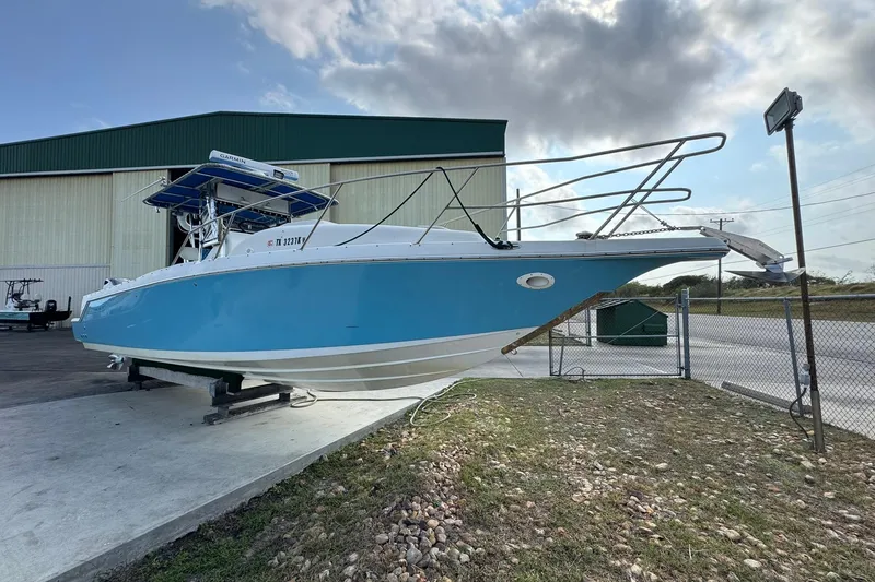 Slide: The Image of 1996 Pro-Line 3400 Cuddy boat on display outside a storage facility. - 3