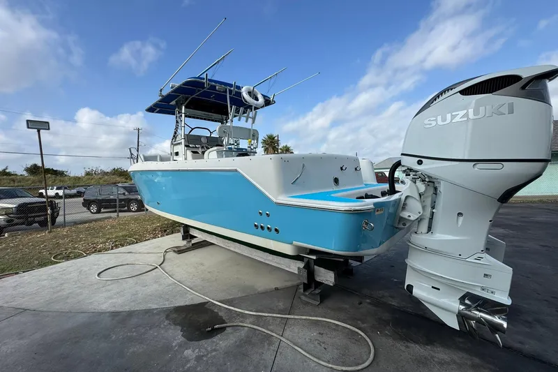 Slide: The Image of 1996 Pro-Line 3400 Cuddy boat with Suzuki outboard motor, parked on concrete. - 4