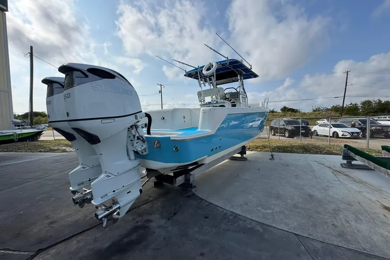 Slide: The Image of 1996 Pro-Line 3400 Cuddy boat with twin Suzuki outboard motors on a sunny day. - 5
