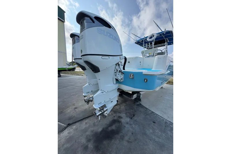 Slide: The Image of 1996 Pro-Line 3400 Cuddy boat with dual Suzuki outboard motors on display. - 7