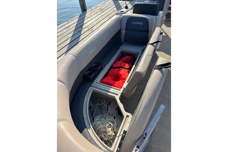 Slide: The Image of 2024 Harris HCX23 boat seat storage with life jackets and rope. - 6