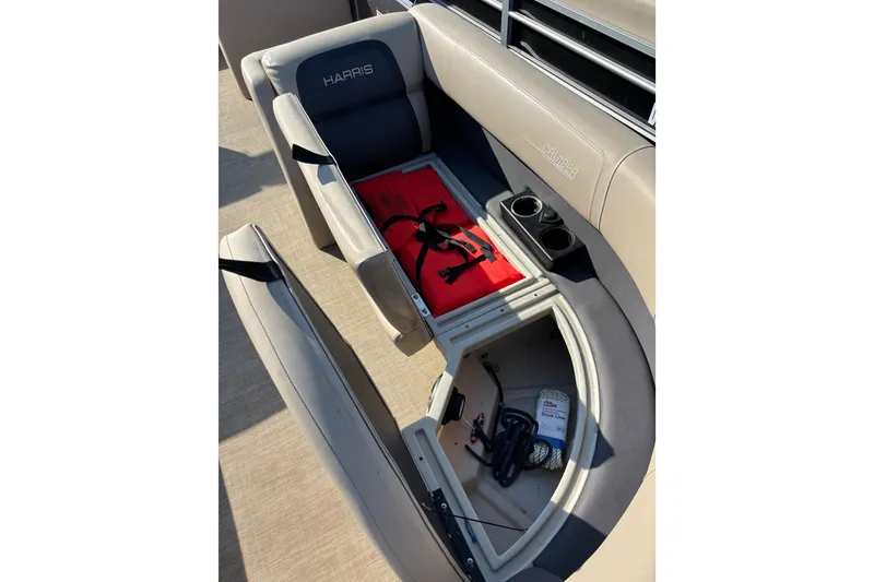 Slide: The Image of 2024 Harris HCX23 boat seat storage with life jacket and cup holders. - 7